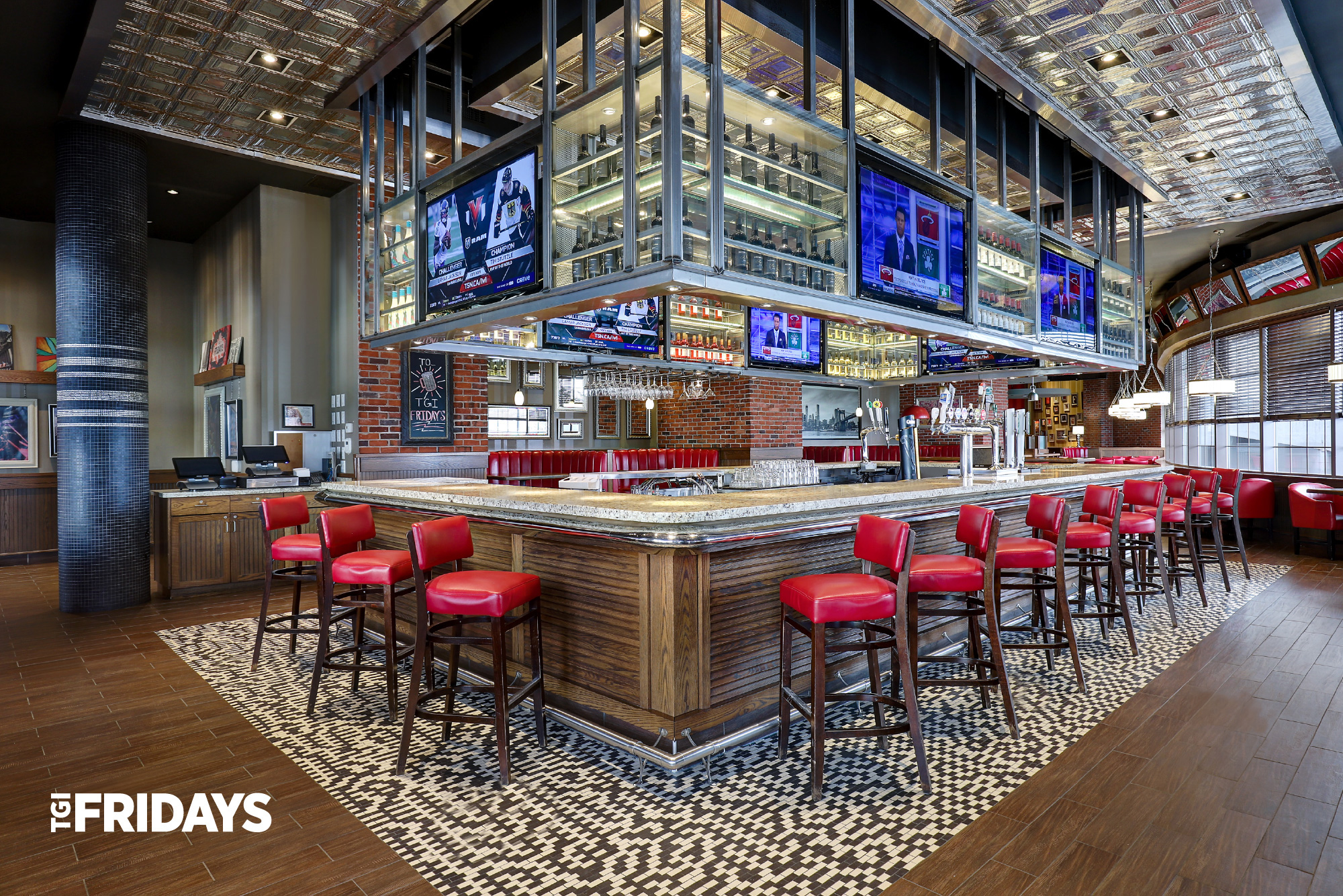 TGI Fridays restaurant interior with cozy booths and warm lighting.